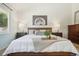 Main bedroom with king bed, stylish decor, and natural light at 2103 Ranch Dr, Westminster, CO 80234