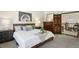 King bedroom with wood dresser and access to loft area at 2103 Ranch Dr, Westminster, CO 80234