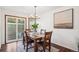 Dining area with wood table and chairs, and access to the patio at 2103 Ranch Dr, Westminster, CO 80234