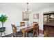Bright dining room with a wood table, chairs, and view to living room at 2103 Ranch Dr, Westminster, CO 80234