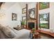 Living room with fireplace and large windows offering backyard views at 2103 Ranch Dr, Westminster, CO 80234