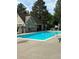Community pool with adjacent building and mature shade trees, creating a refreshing outdoor experience at 2103 Ranch Dr, Westminster, CO 80234