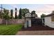 Backyard with grass and mulch, includes a playhouse, slide, and ladder at 2941 Oneida St, Denver, CO 80207