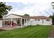 Backyard with a well-maintained lawn, covered patio, and charming exterior details at 2941 Oneida St, Denver, CO 80207