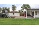 Spacious backyard featuring a playhouse, detached garage, and covered patio for outdoor living at 2941 Oneida St, Denver, CO 80207