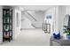 Finished basement area featuring neutral carpet, white walls, and staircase at 2941 Oneida St, Denver, CO 80207