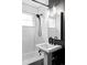 Bathroom featuring pedestal sink, modern fixtures, and subway tile, combining style and functionality at 2941 Oneida St, Denver, CO 80207