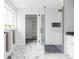 Elegant bathroom with a glass-enclosed shower, marble flooring, and ample closet space at 2941 Oneida St, Denver, CO 80207