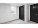 Bedroom with neutral carpet, white walls, a window and closet featuring modern black doors at 2941 Oneida St, Denver, CO 80207