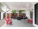 Covered patio area with modern outdoor furniture and lighting, perfect for entertaining at 2941 Oneida St, Denver, CO 80207