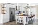 Modern kitchen with stainless steel appliances, a central island, and sleek white cabinetry at 2941 Oneida St, Denver, CO 80207