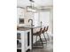 Kitchen island featuring bar seating, modern light fixture, and ample counter space, perfect for entertaining at 2941 Oneida St, Denver, CO 80207