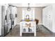 Modern kitchen featuring stainless steel appliances, a spacious island, and stylish hexagonal tile flooring at 2941 Oneida St, Denver, CO 80207