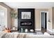 Cozy living room showcasing a modern fireplace, neutral decor, and stylish furnishings at 2941 Oneida St, Denver, CO 80207