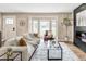 Inviting living room featuring hardwood floors, a bay window, and a contemporary fireplace feature at 2941 Oneida St, Denver, CO 80207