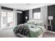 Bright main bedroom with sliding glass doors to the backyard, dark accent wall, and plush bedding at 2941 Oneida St, Denver, CO 80207