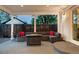 Covered patio featuring a modern sofa, accent pillows, and an outdoor fire pit table at 2941 Oneida St, Denver, CO 80207