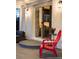 Close up of the covered patio showing a red outdoor chair near sliding glass doors to the interior at 2941 Oneida St, Denver, CO 80207
