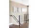 Modern staircase with metal railings and hardwood floors, adding a touch of elegance to the home at 2941 Oneida St, Denver, CO 80207