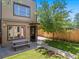 The backyard has a picnic table and a beautiful tree at 2741 Java Ct, Denver, CO 80211