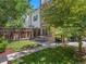 Green backyard featuring a patio with a picnic table, privacy fence, and shade trees for relaxing outdoor living at 2741 Java Ct, Denver, CO 80211