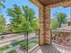 Charming balcony featuring stone pillars, a metal railing, and views of the neighborhood at 2741 Java Ct, Denver, CO 80211