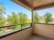 Private balcony with wood decking, metal railings, and serene treetop views at 2741 Java Ct, Denver, CO 80211