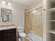 Bathroom featuring a tiled shower stall with glass door, vanity with granite top, and modern fixtures at 2741 Java Ct, Denver, CO 80211