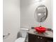 Powder room with bright red glass vessel sink and wall mirror at 2741 Java Ct, Denver, CO 80211
