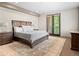 Spacious bedroom with a large bed, stylish decor, and access to a balcony at 2741 Java Ct, Denver, CO 80211