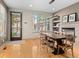Dining room with hardwood floors, a stone fireplace, and a modern light fixture at 2741 Java Ct, Denver, CO 80211