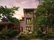 Stylish multi-story home with stone facade and balcony, surrounded by lush landscaping at 2741 Java Ct, Denver, CO 80211