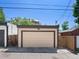 A detached two-car garage with a neutral-colored door and trim, accessible from the back alley and street at 2741 Java Ct, Denver, CO 80211