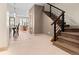 Spacious hallway with tile flooring and view of stairs and open kitchen/dining space at 2741 Java Ct, Denver, CO 80211