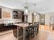 Modern kitchen featuring a large island with bar seating, stainless steel appliances, and dark wood cabinetry at 2741 Java Ct, Denver, CO 80211