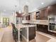 Bright and open kitchen with an island cooktop, stainless steel appliances, and plenty of counter space at 2741 Java Ct, Denver, CO 80211