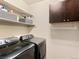 Laundry room with modern appliances, ample storage, and well-organized shelving at 2741 Java Ct, Denver, CO 80211