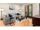 Comfortable living room with hardwood floors, large windows, and a neutral color palette at 2741 Java Ct, Denver, CO 80211