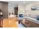 Open-concept living room with hardwood floors and view of staircase and dining area at 2741 Java Ct, Denver, CO 80211