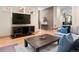 Open living room with modern entertainment center, hardwood floors and stylish décor at 2741 Java Ct, Denver, CO 80211