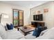 Stylish living room with large windows, hardwood floors, and comfortable seating area at 2741 Java Ct, Denver, CO 80211