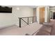 Cozy loft with TV, comfortable seating, carpeted floor, and modern railing at 2741 Java Ct, Denver, CO 80211