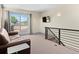 Cozy loft with access to outdoor deck, TV, comfortable seating, and modern railing at 2741 Java Ct, Denver, CO 80211