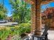 Cozy front porch features stone columns, Adirondack chairs, and beautiful landscaping at 2741 Java Ct, Denver, CO 80211