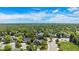 Expansive aerial view of a residential neighborhood surrounded by lush greenery and open skies at 7696 S Hudson Way, Centennial, CO 80122