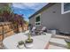 Cozy backyard patio with modern furniture, a wooden fence and a sleek grey exterior at 7696 S Hudson Way, Centennial, CO 80122
