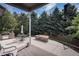 Beautiful backyard featuring a fire pit, mature trees, and an outdoor kitchen at 7696 S Hudson Way, Centennial, CO 80122