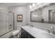 Bright bathroom featuring double sink vanity with marble counters and subway tile shower at 7696 S Hudson Way, Centennial, CO 80122