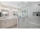 Spa-like bathroom features double sinks, a glass enclosed shower, and modern fixtures for ultimate relaxation at 7696 S Hudson Way, Centennial, CO 80122