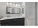 Stylish bathroom features double sinks with a marble countertop, modern vanity, and custom storage solutions at 7696 S Hudson Way, Centennial, CO 80122